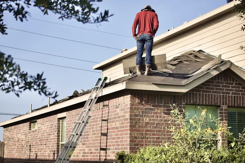 Professional roofer working on a residential roof in Pendergrass